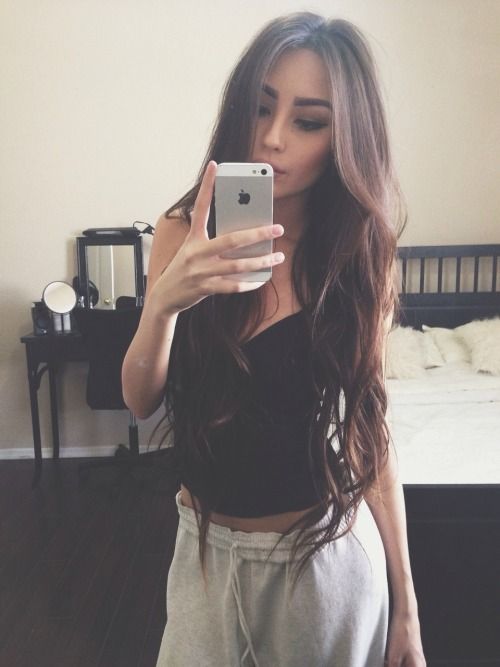 amateur brunette beauty taking a selfie