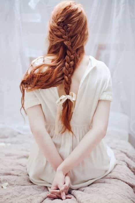 Red-haired white beauty with braided hair