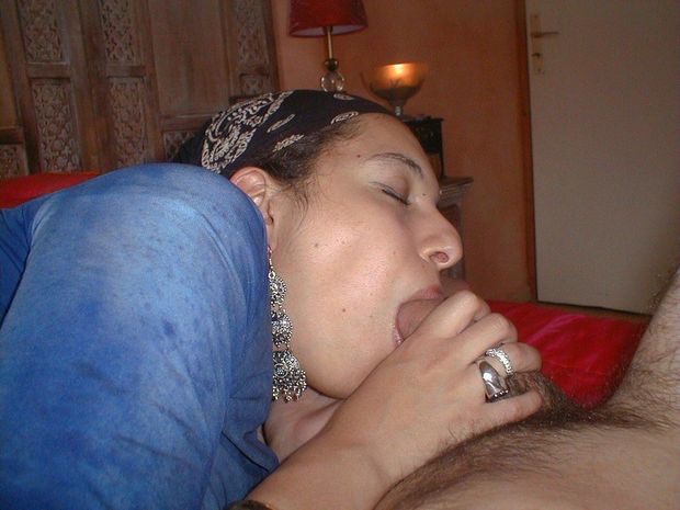 With her eyes closed, the Muslim lady gently sucks the dick