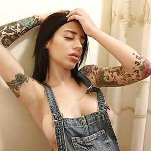 Alex Mucci in overalls barely covered by disrespectful edits