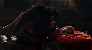 werewolf ravishes woman in a graveyard