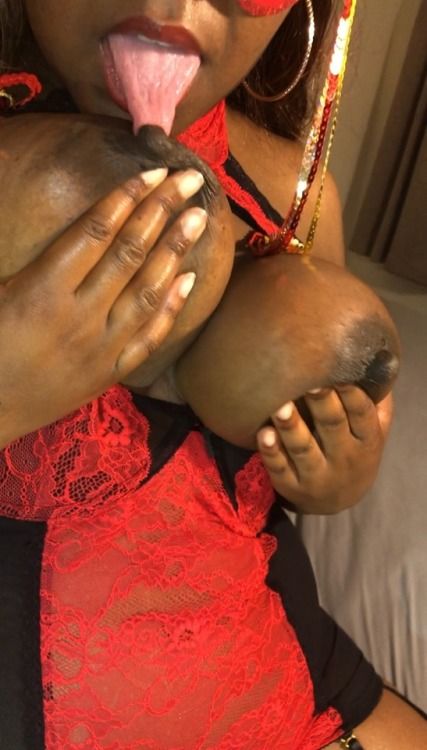 Licking ebony nipples