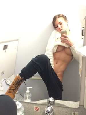 Brunette masturbates in public bathroom