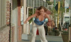 Retro 70s Babe Skateboarding with bouncing Tits Cleavage