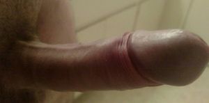 Erect penis in bathroom.