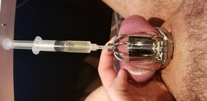 injecting hot coconut oil into my caged cock