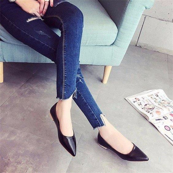 Sexy feet with pointed black flats