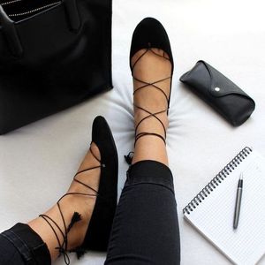 Black criss cross flats and tight jeans