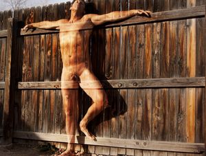 artistic shot of nude male blending in with his surroundings