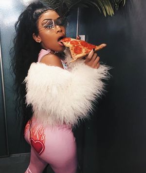 Deborah Gibbs Hung munches on a beautiful pepperoni pizza for you