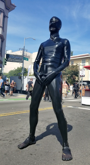 Presenting my sheathed rubber cock and balls to the crowd at Folsom