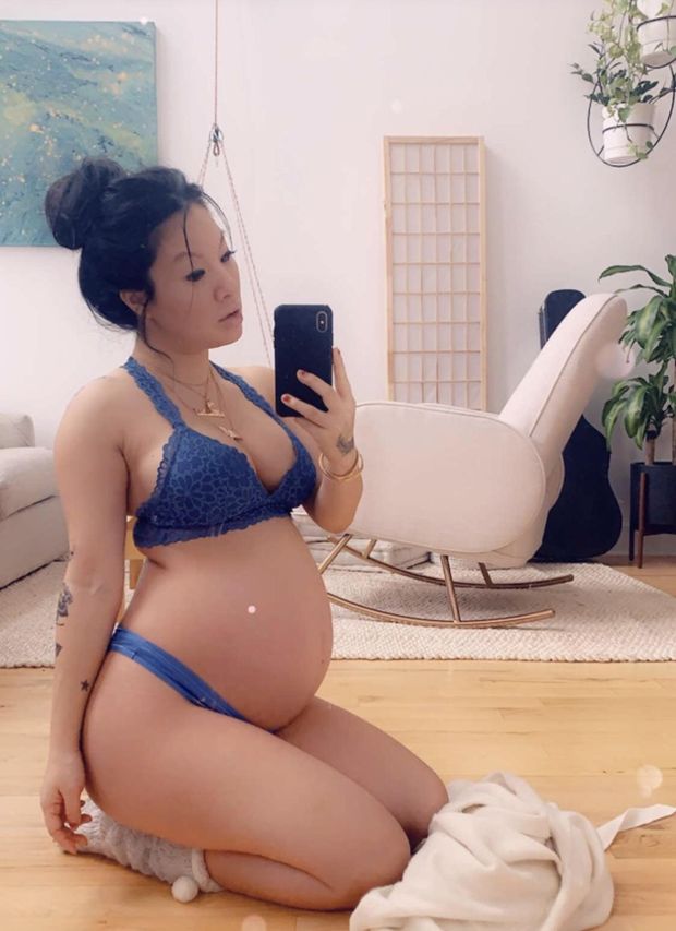 Asa Akira showing her pregnant stomach