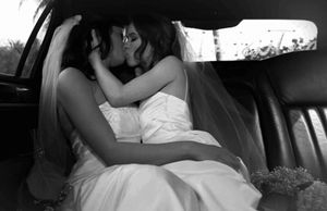 lesbians kiss in wedding attire