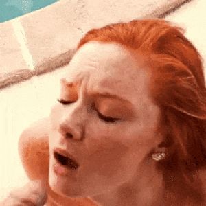 Redhead taking a load of cum on her face
