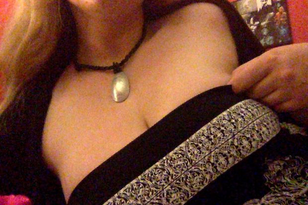 Blonde wearing sexy summer dress showing light cleavage