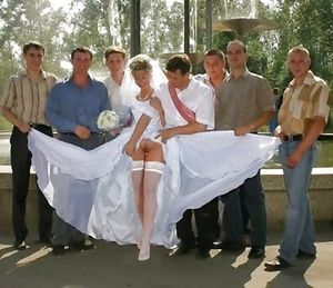 The bride's pussy is exposed by her friends.