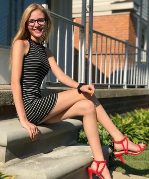 Tall leggy blonde with glasses in red high heels