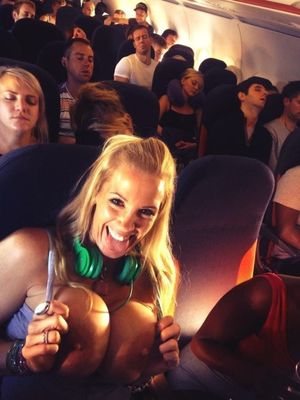 Sexy blonde flashing great boobs on an airplane