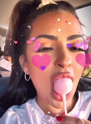 Nilsa licks lollipop