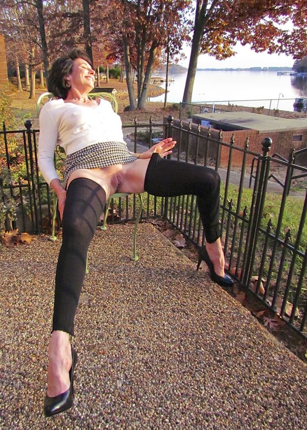 Beauty gilf is spreading her legs outside