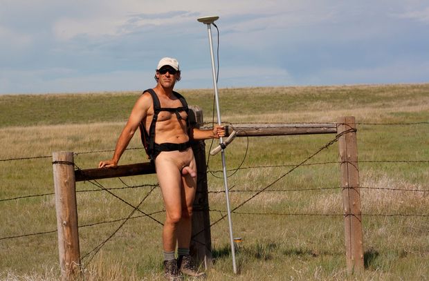 nude male bored at work displaying semi erect cock and balls while surveying outdoors