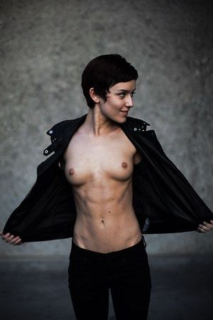 Short-haired brunette tomboy flashing her tits.