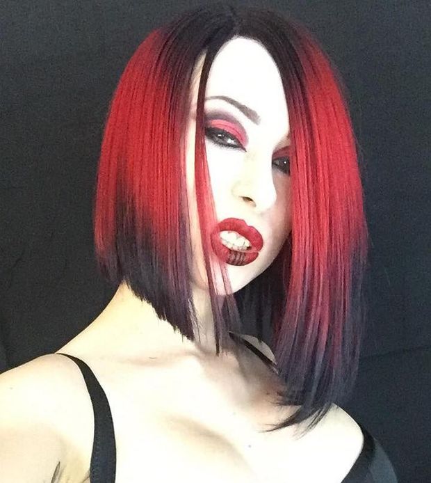 Sandra Satan snarls at you with her deadly sexy non-nude emo facial expression & goth cleavage