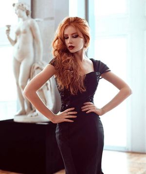 Stunning redhead in tight black dress