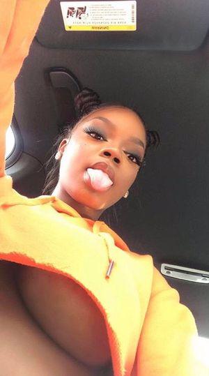 Busty ebony slut shows her tits