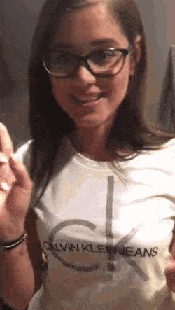 Teen in glasses on her knees sucking cock
