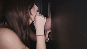 Teen in gloryhole booth choking on cumshot
