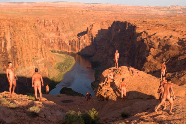 composite photoshop of nude male hiking near canyon