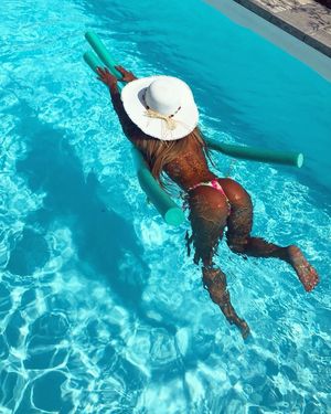 hard tanned body floating in the pool