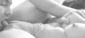 Licking her while holding her boob