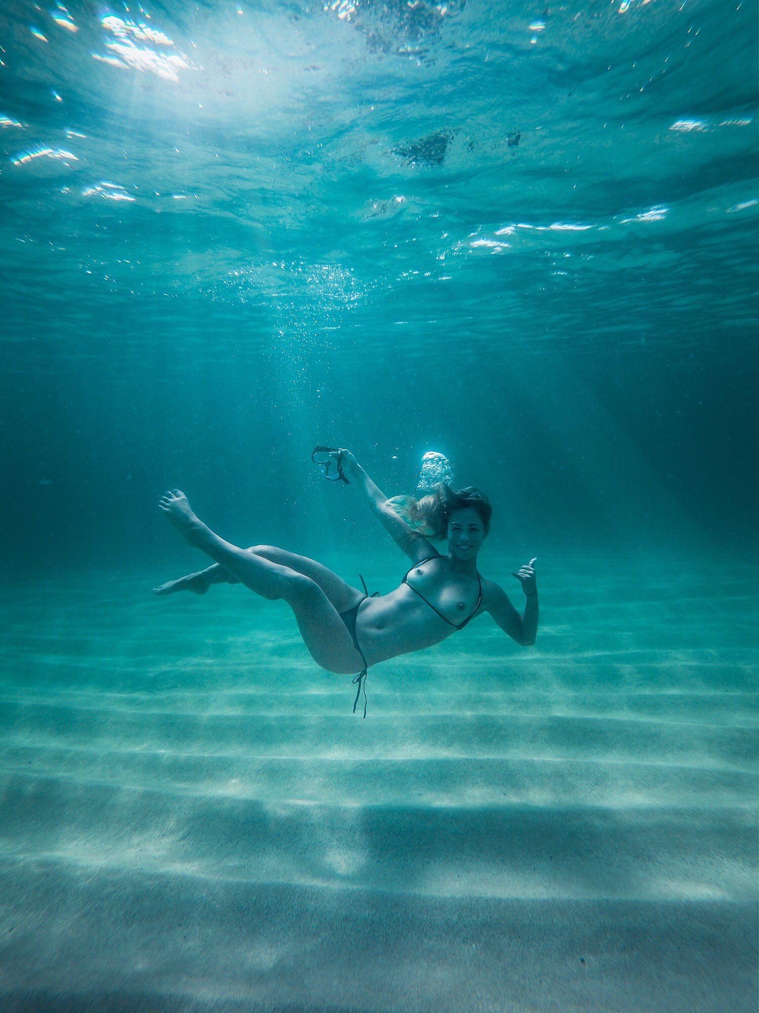 Cutie flashing her tits deep underwater