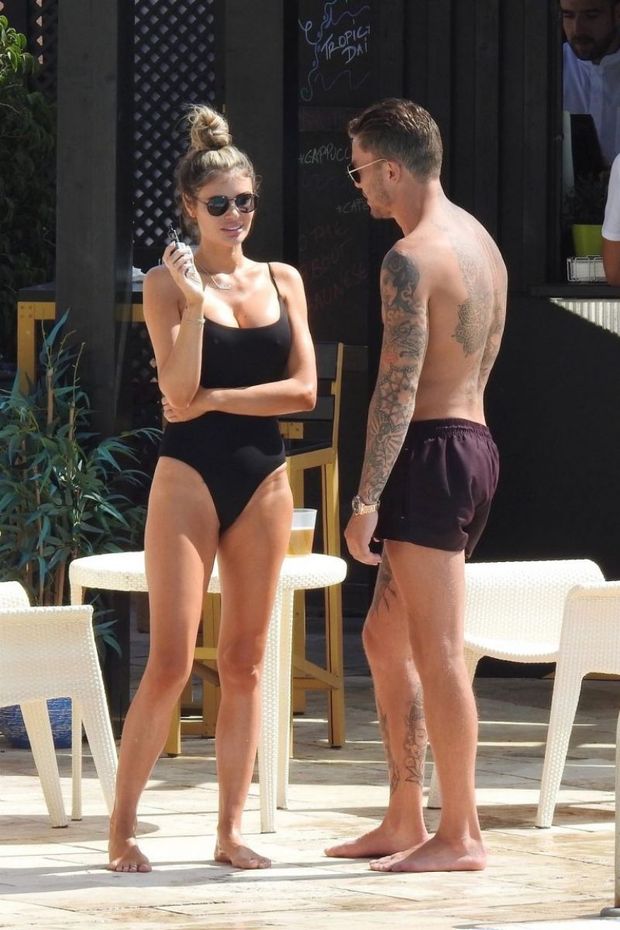 Chloe Sims sexy ass in a thong swimsuit also showing nice cleavage with her big tits seen by paparazzi in Spain by the pool.