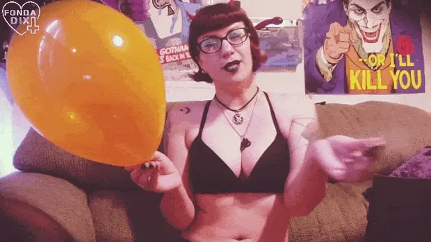 Popping an orange balloon with a little cigarette & giggling.
