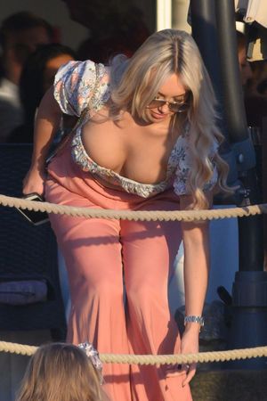 Amber Turner braless boobs showing nice cleavage bending over seen by paparazzi.