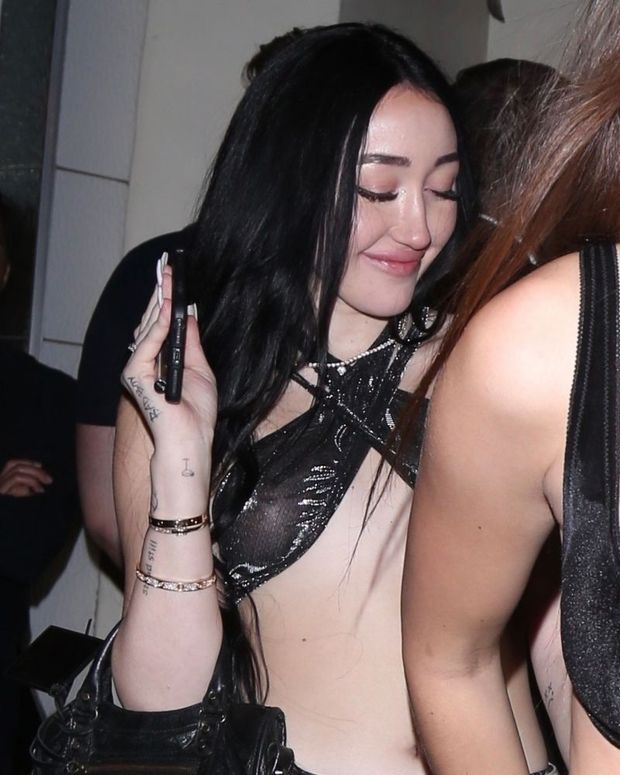 Noah Cyrus braless boobs in a see through sexy little top showing off her tits seen by paparazzi going out to the club on New Years Eve.