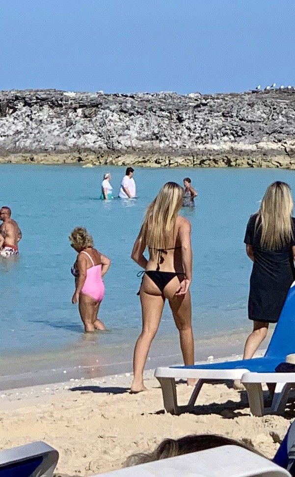 Hot blonde milf walking on beach in Bahamas