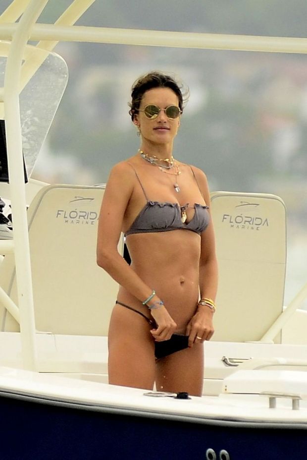Alessandra Ambrosio sexy ass in a bikini and showing nice cleavage with her big tits showing off her perfect model body seen by paparazzi.