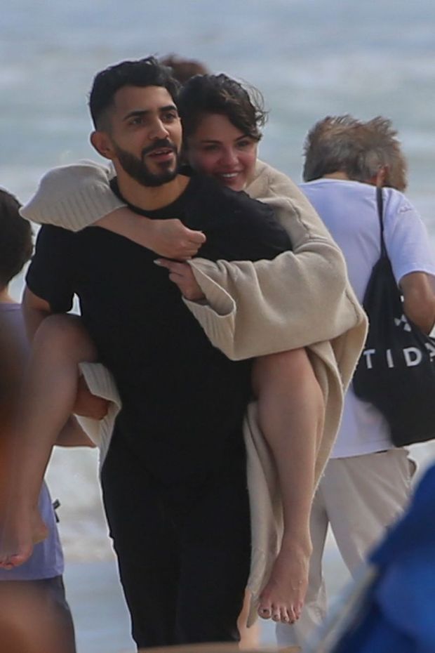 Selena Gomez in a sexy bikini seen by paparazzi on the beach in Hawaii where she was stung by a jellyfish and had to be carried.