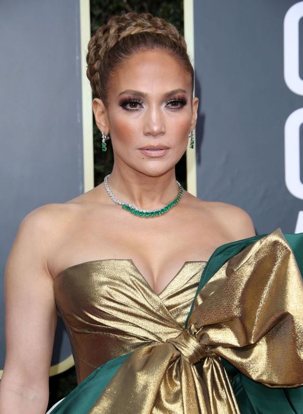 Jennifer Lopez big boobs showing nice cleavage in a sexy dress photographed arriving to the Golden Globe Awards.