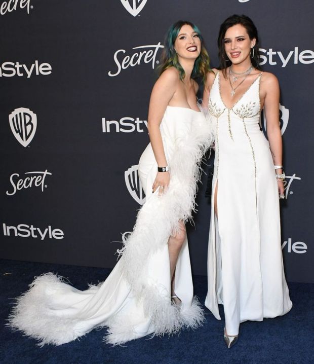 Bella Thorne and Dani Thorne photographed arriving to the Golden Globes after party both in sexy white dresses showing nice cleavage.