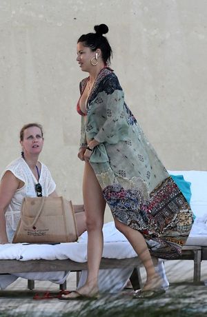 Adriana Lima in a sexy bikini showing nice cleavage with her big tits and ass seen by paparazzi in Miami.