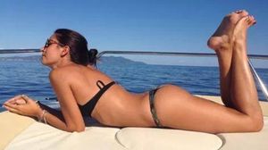 Beautiful Boating Brunette Suns in Her Thong Bikini