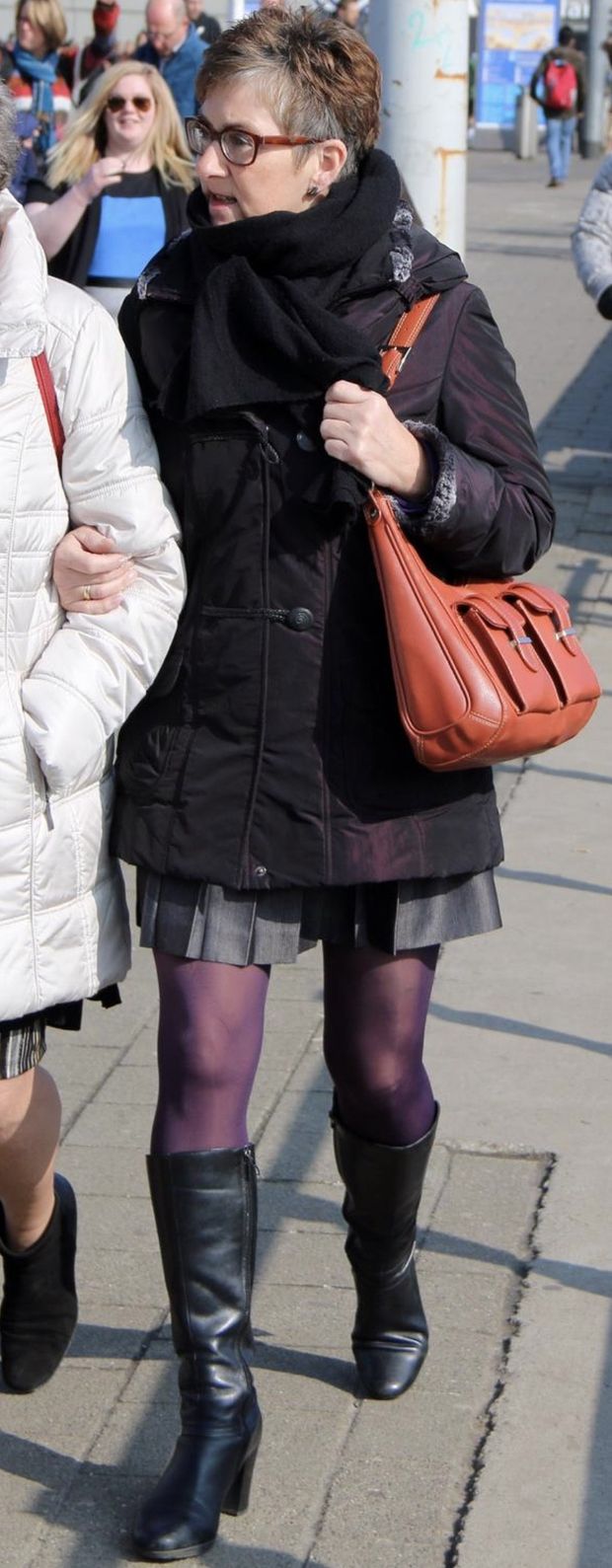 Candid mature woman in pantyhose and boots