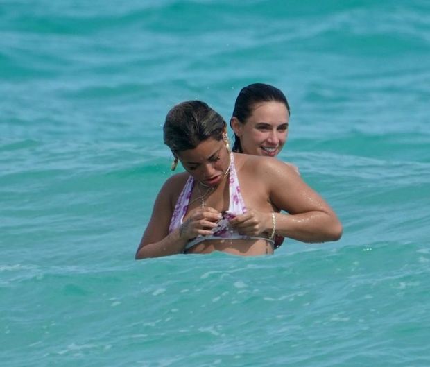 DaniLeigh nip slip wardrobe malfunction accidentally flashing her tits seen by paparazzi in Miami in the water wearing a sexy bikini.