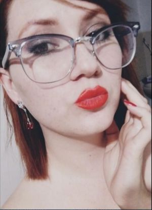 Cute teen in glasses and red lipstick.