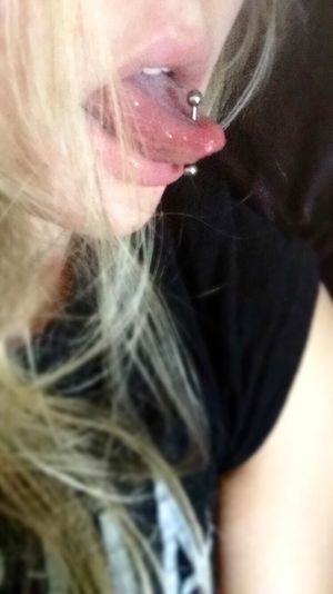 Blonde with a pierced tongue